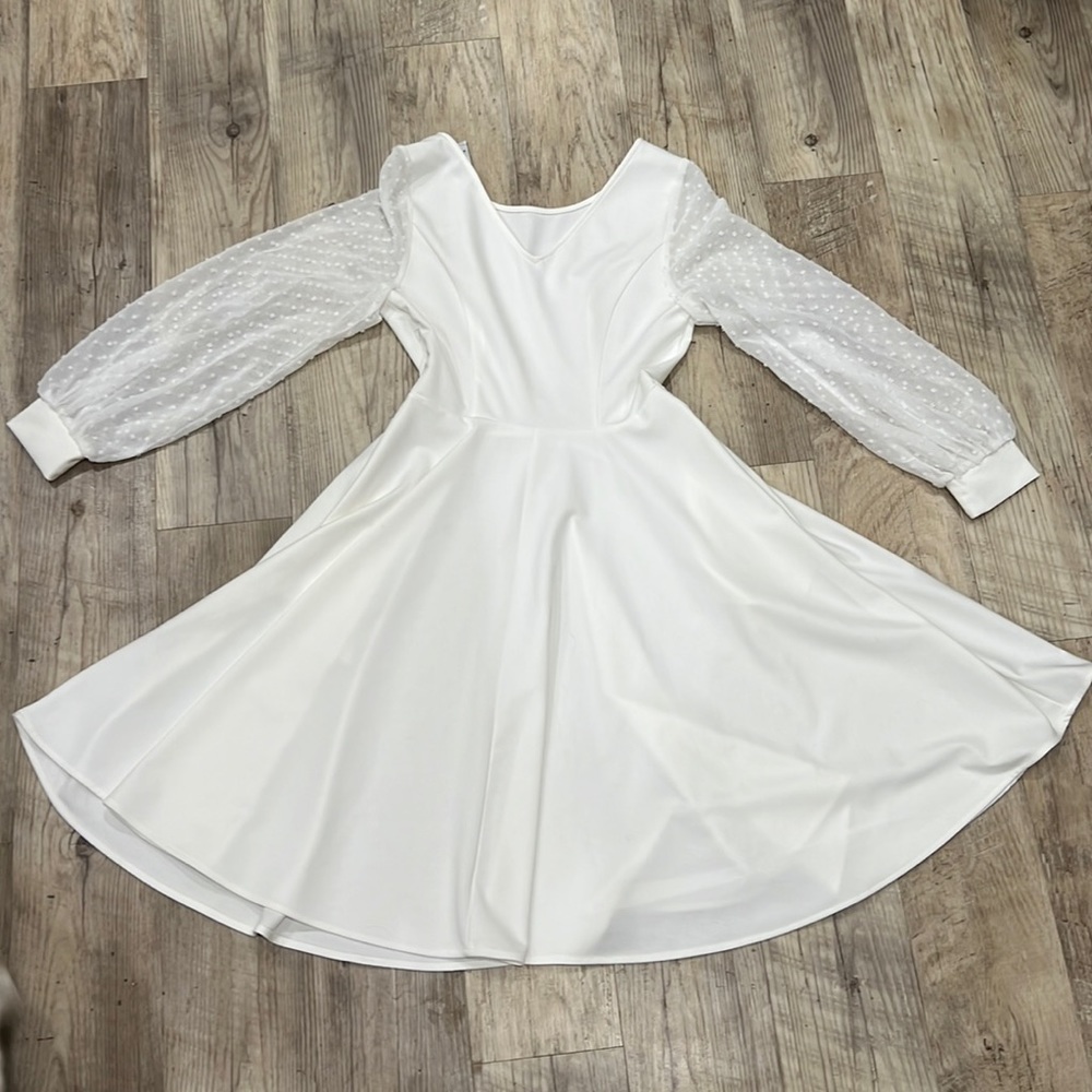 White dress with mesh polka dot sleeves.